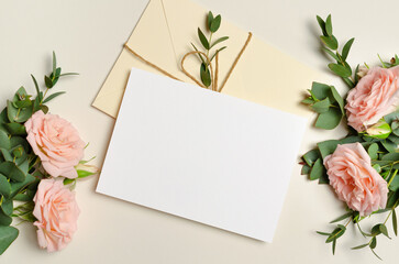 Wedding invitation card mockup with envelope and roses flowers, blank card mockup