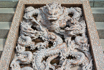 Chinese dragon bas-relief on stairs in Daci buddhist temple in downtown Chengdu, Sichuan province, China - 581031851