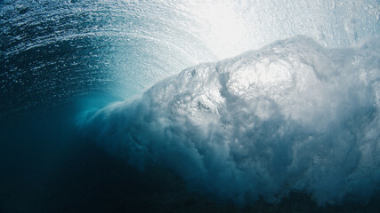 Underwater view of the ocean wave breaking on the shore in the Maldives