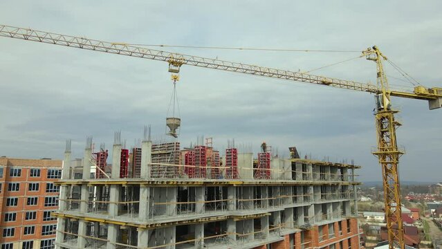 Tower cranes at high residential apartment buildings construction site. Real estate development