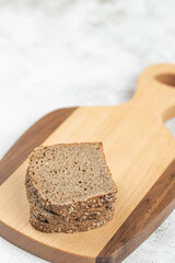 Sliced integral bread on the wooden cutting board with copy space
