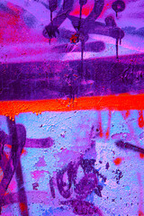 Closeup of colorful purple, orange, black urban wall texture. Modern pattern for wallpaper design. Creative modern urban city background for advertising mockups. Grunge messy street style background
