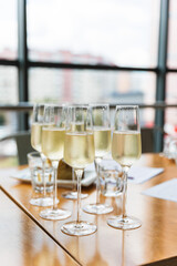 Catering services. glasses with cold wine in row background at restaurant party.