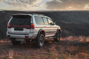 Fototapeta na wymiar SUV crossover car at sunset. Travel and journey 4wd car.