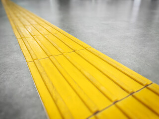 Walkway or yellow tactile tiles for the blind in the urban environment.