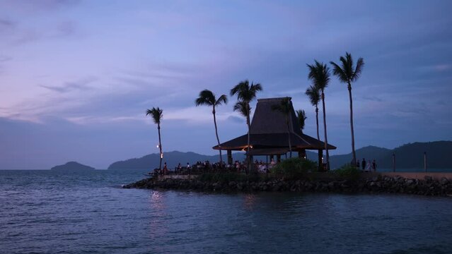 People Tourists Enjoy Sunset at Tanjung Aru Beach at Kota Kinabalu Shangri-la Resort