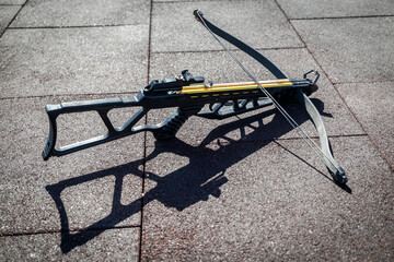 Modern sports crossbow lies on the sports ground at team building sports games.