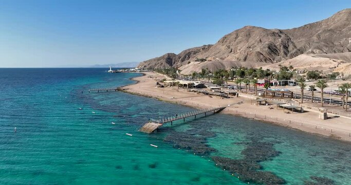 Aerial footage of a pier made of wood near Eilat Coral Beach Nature Reserve. Filmed in C4K Apple ProRes 422 HQ