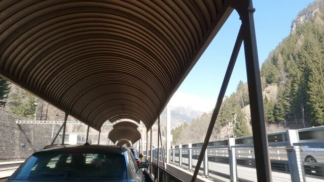 Unique Perspective of Cars being Transported by Train in Switzerland