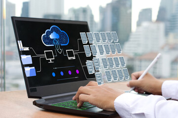 businessman working on a laptop using FTP (File Transfer Protocol) with a paperless system.