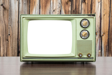 Old green television with wood wall and cut out screen.