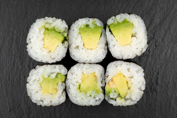 Above ground Japanese sushi food. Maki and rolls with tuna, salmon, shrimp, crab and avocado. Top view of various sushi, all you can eat menu. Rainbow sushi roll, uramaki, hosomaki and nigiri.