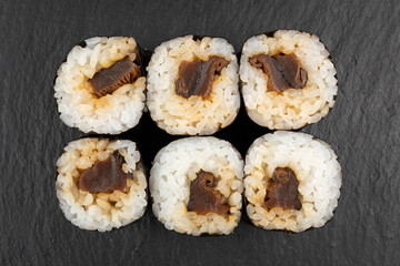 Above ground Japanese sushi food. Maki and rolls with tuna, salmon, shrimp, crab and avocado. Top view of various sushi, all you can eat menu. Rainbow sushi roll, uramaki, hosomaki and nigiri.