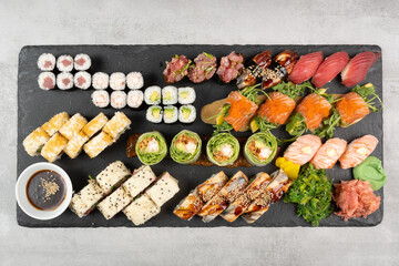 Above ground Japanese sushi food. Maki and rolls with tuna, salmon, shrimp, crab and avocado. Top view of various sushi, all you can eat menu. Rainbow sushi roll, uramaki, hosomaki and nigiri.