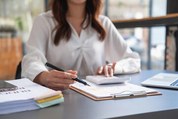 Marketing, Financial, Accounting, Planning, business women analyze company results and profits with graph statistics. Use a laptop computer and a calculator to calculate the company is balance.