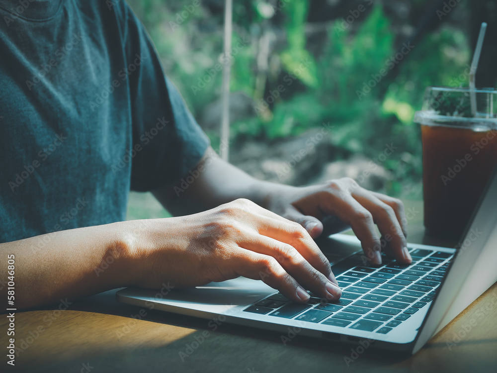 Poster man typing documents or searching on laptop with nature background. light shines through. the image 