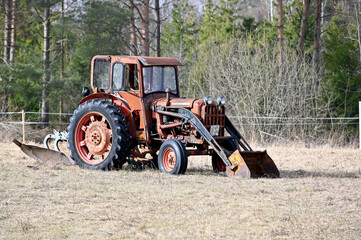 odl red trector standing on field of grass