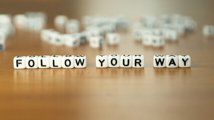 Follow your way slogan in white block letter beads 