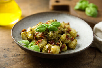 Homemade potato gnocchi with pesto and tomatoes
