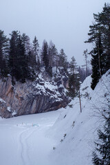 Beautiful snowy mountain park Ruskeala in the Republic of Karelia, Russia in winter. marble quarry