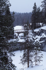 Snowy mountain park Ruskeala in the Republic of Karelia, Russia in winter. marble quarry and bridge