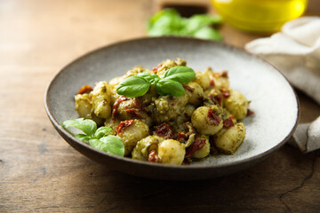 Homemade potato gnocchi with pesto and tomatoes