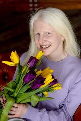 albino girl with a beautiful bouquet of colorful tulips