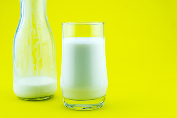 Banner of a glass of milk on colorful yellow background Milk day Copy space