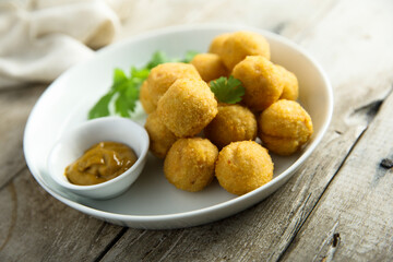 Homemade salmon croquettes with mustard