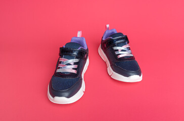 Sneakers on a pink background. There is space for text.