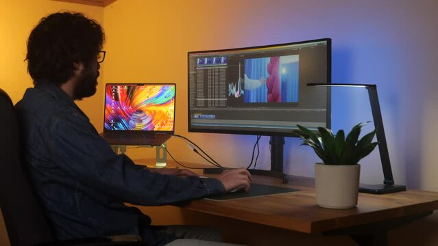 Timelapse busy young adult video editor working on content footage production in studio workspace