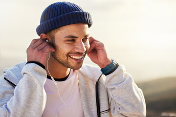 Man with earphones, listening to music and smile outdoor with runner, fitness and motivation with...