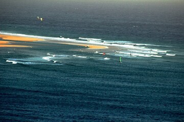 Aerial view of a beach many km long. Tongues of sand brought back by the tides. Contrast between...