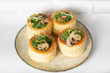 savory puff cups with ham, mushroom and vegetables, selective focus
