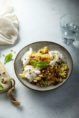 Pasta with fresh cheese and tomatoes