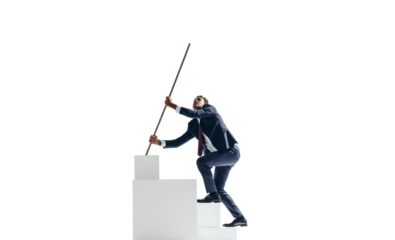 Ambitious young businessman working his way to the top of a block of stairs on a transparent background