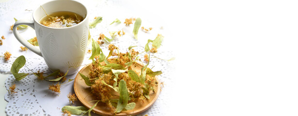 Banner. White mug with linden flower tea. Dried linden flowers.Selective Focus