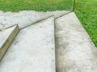 Abstract steps or stairs shape pattern, rough and dirty cement or concrete floor texture and background space with green grass and mirror reflection.