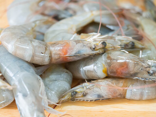 Closeup of fresh shrimp on wooden cutting board in the kitchen or shrimp prawns in the market.