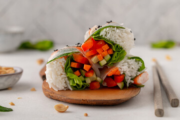 Summer rolls with fresh vegetables and shrimps and peanut sauce. Vietnamese appetizer. Salad spring rolls with prawns. Healthy food concept