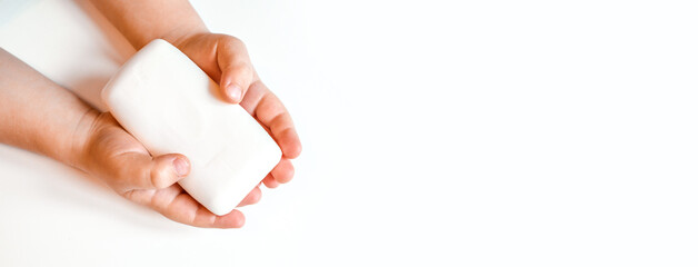 Hand washing with soap. a small child is holding soap in his hands . Isolate on a white background. banner. the concept of cleanliness and hygiene