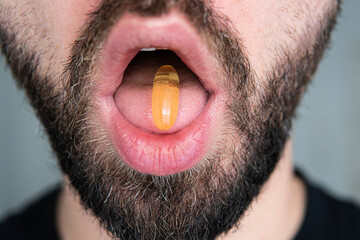 fish oil tablet on the tongue
