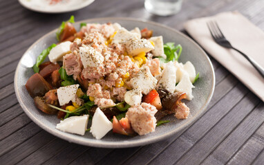 Plate of salad with tuna, corn, tomatoes and arugula