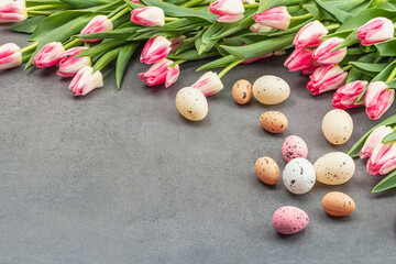 Easter flat lay with colorful eggs and tulips. Traditional decor, festive greeting card, holiday
