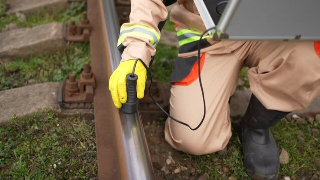 engineer worker search for defects in railway railway sleepers and steel rails