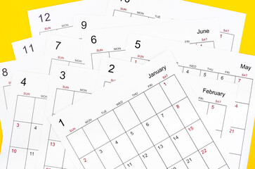 The Many calendar page on yellow background business schedule planning appointment meeting concept.