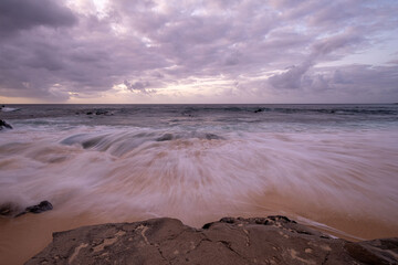 Oceanscape during the sunset with waves and rock, Ascension island.