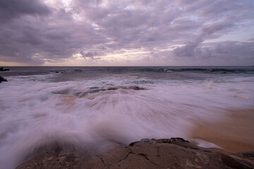 Oceanscape during the sunset with waves and rock, Ascension island.