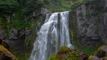 Fototapeta premium Russia, Kamchatka. A full-flowing mountain waterfall near Tolbachik volcano.