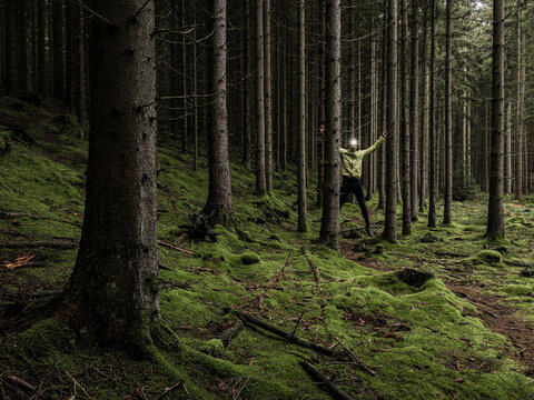 Man running through forest
